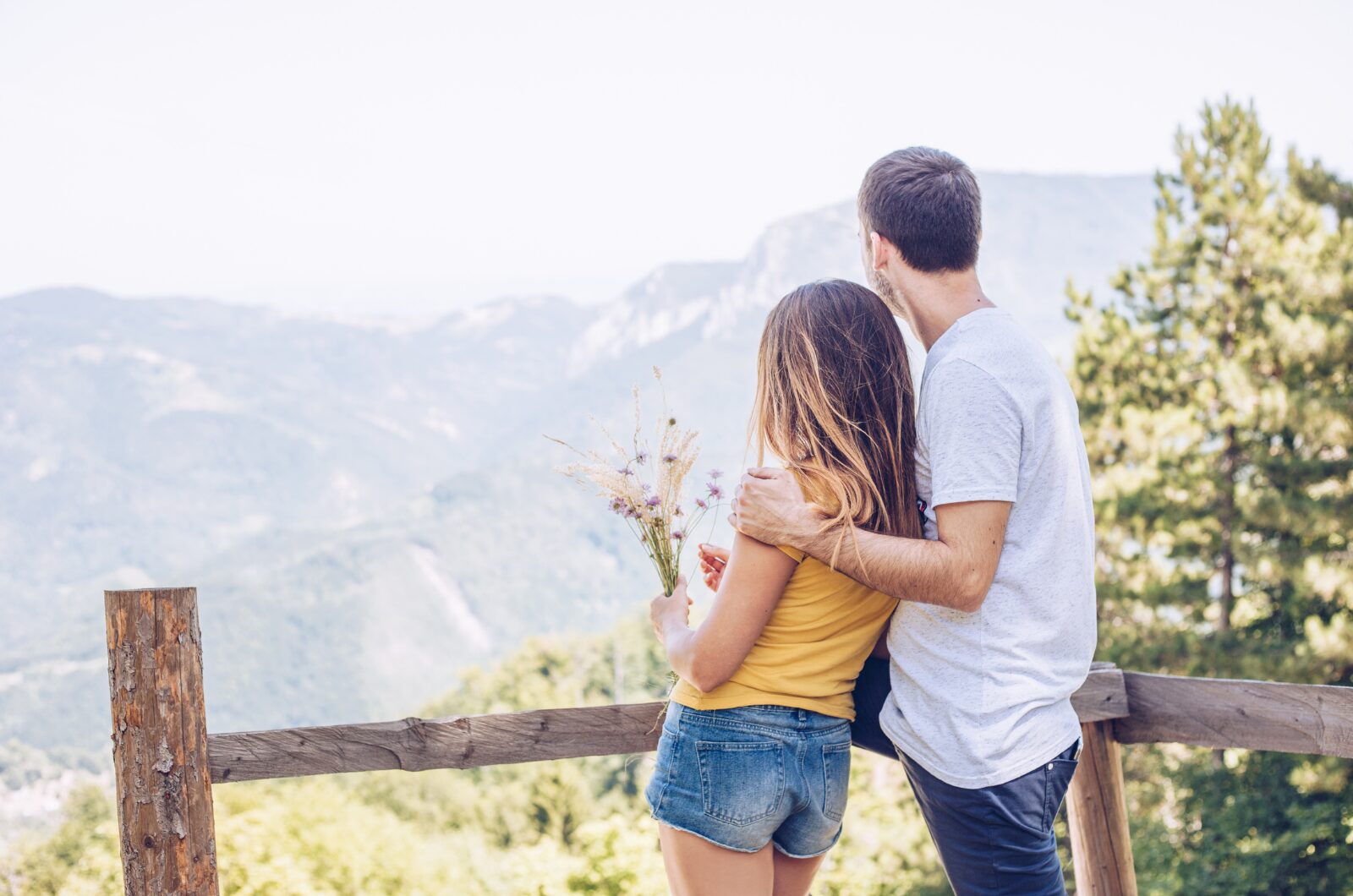 Happy couple laughing together indoors, showing emotional safety, connection, and freedom in a stable relationship