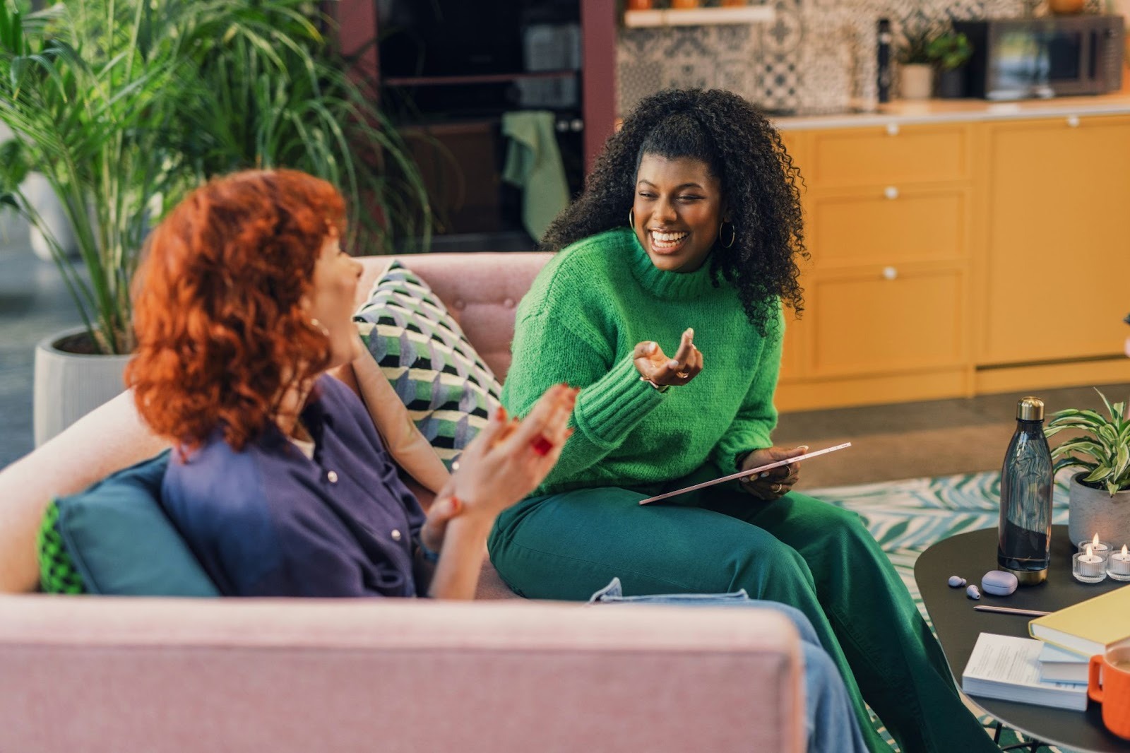 a woman talking to a female therapist wearing a green sweater for emotional wealth at Mindful Guides Therapy Center