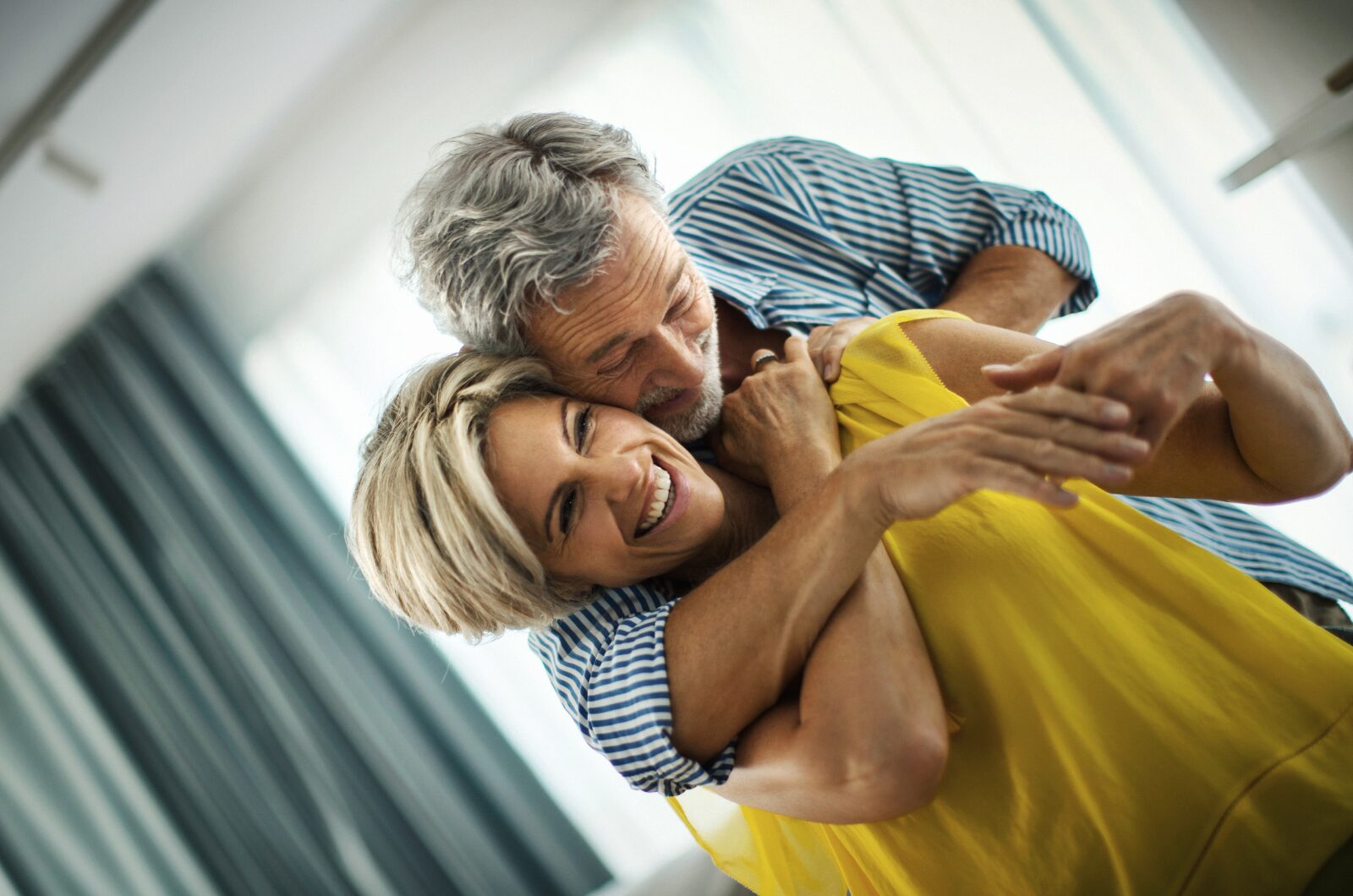 Older couple sharing a gentle embrace, feeling emotionally safe, deeply connected, and present together