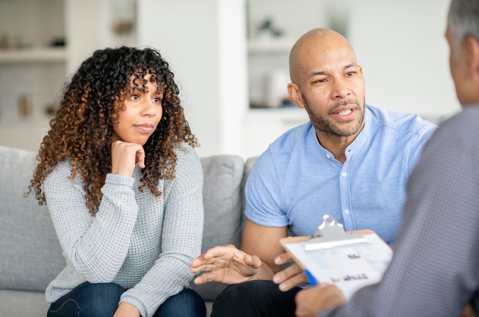 Couple sharing feelings with a relationship therapist during couples counseling session in a calm, supportive setting
