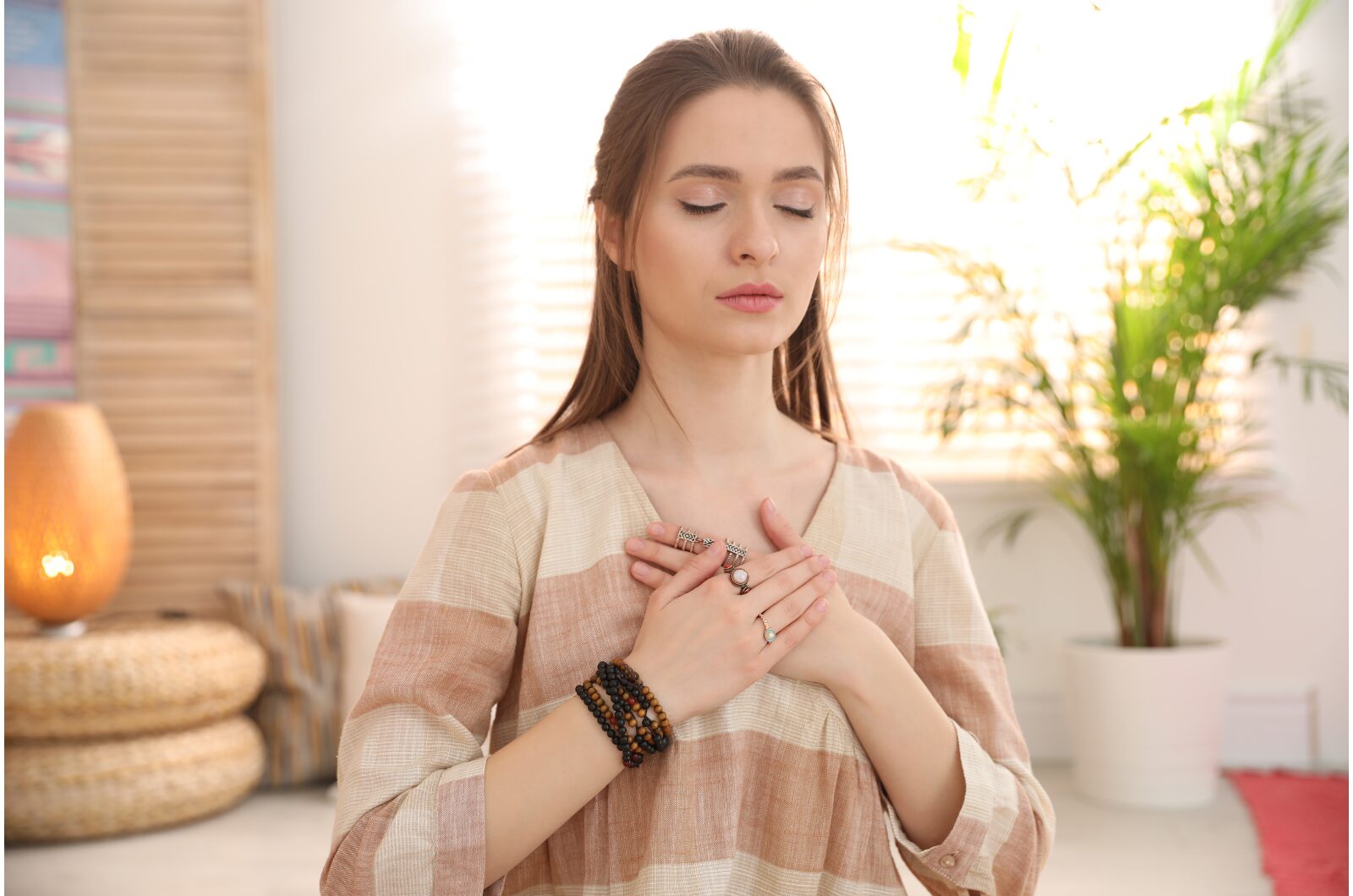 What to Expect in a Somatic Therapy Session: A Beginner's Guide Young woman practicing somatic therapy with eyes closed, hands on chest, focusing on mindful body awareness.