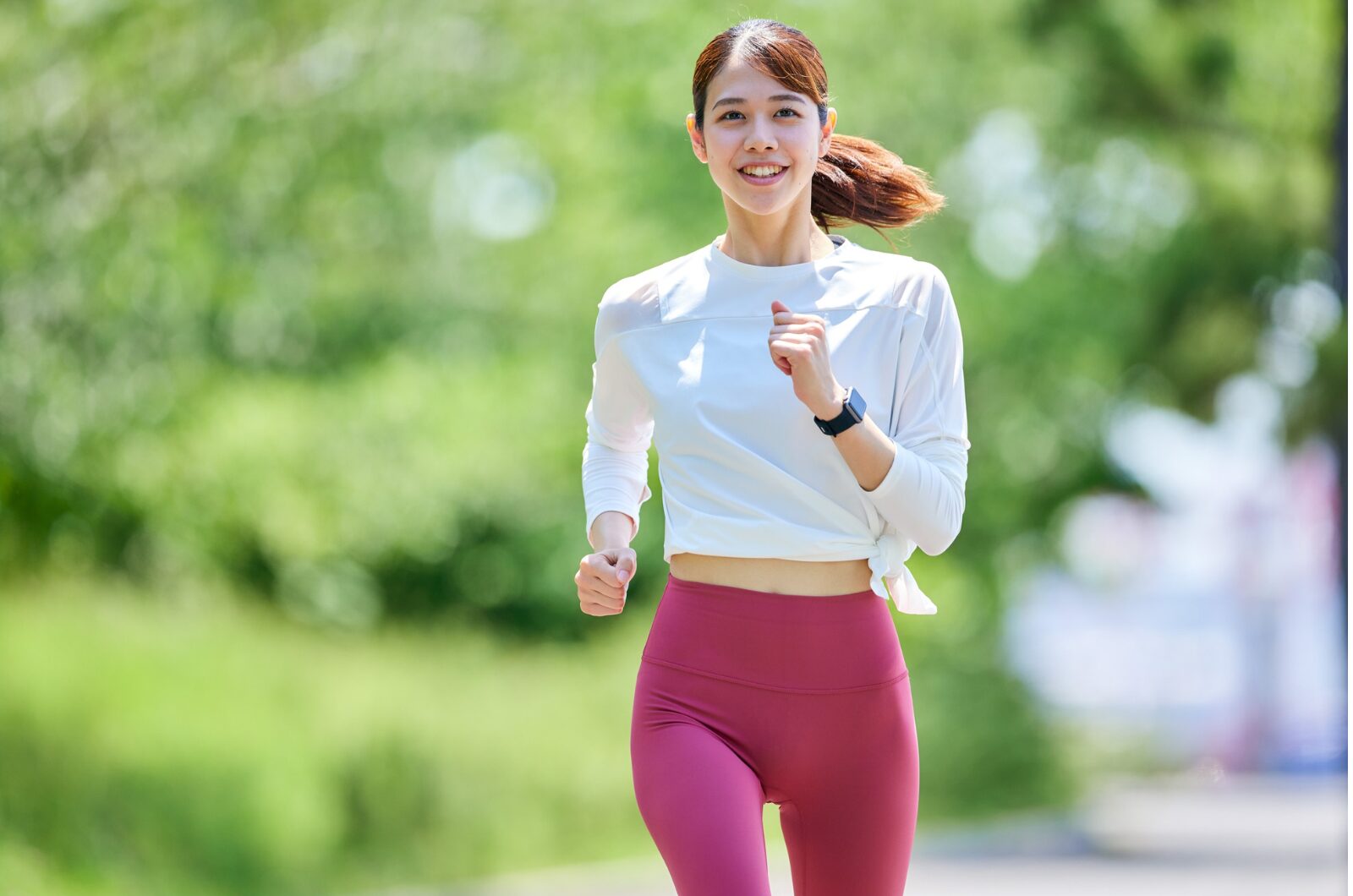 How to Set Realistic Goals for Therapy and Track Your Progress A woman runs along a sunny park path, symbolizing steady progress and motivation in achieving therapy goals.