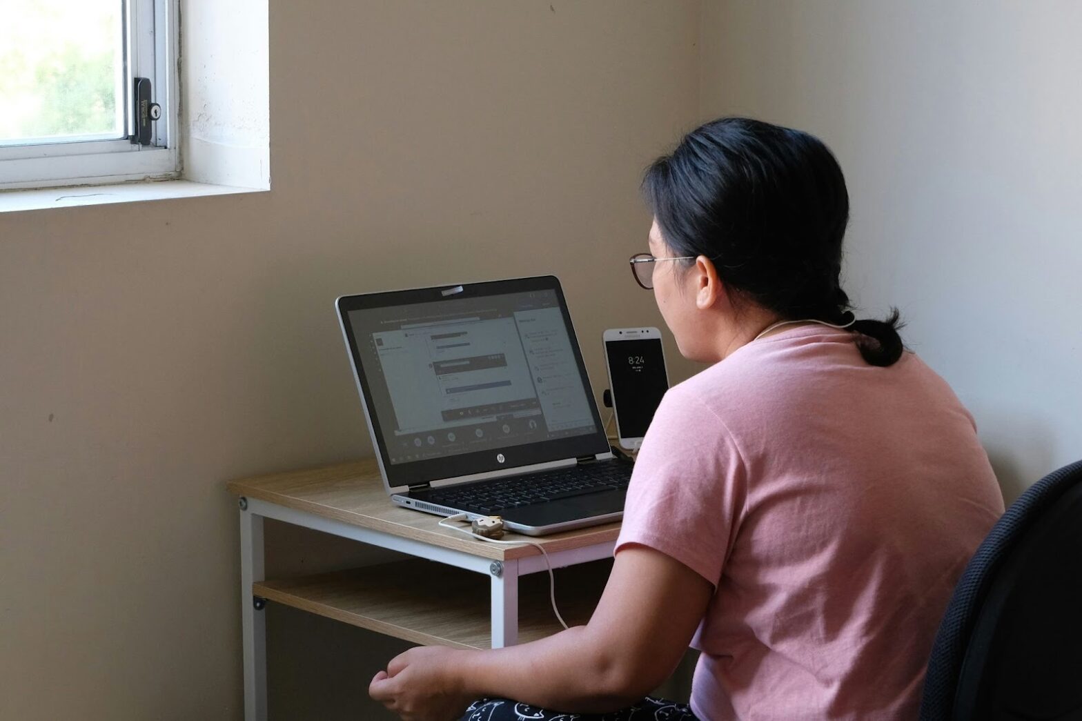 Women attending an online counseling session on a laptop from home, highlighting remote mental health support