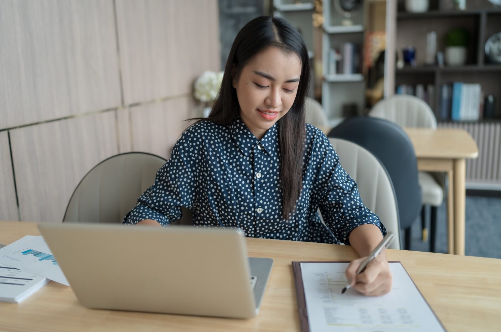 Practical Strategies for San Diegans Navigating Career, Relationship, and Life Changes Woman working on a laptop while taking notes, reflecting on focus, career growth, and clarity during life transitions